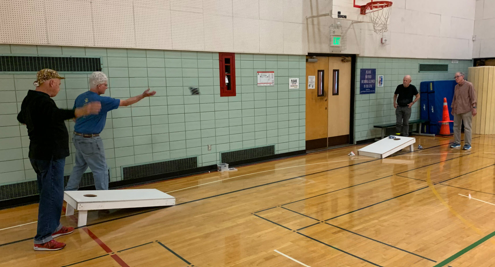 men playing cornhole