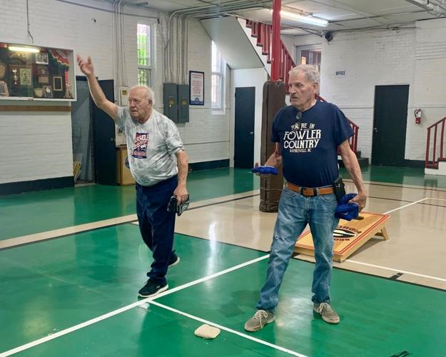 Men Playing Cornhole Indoors