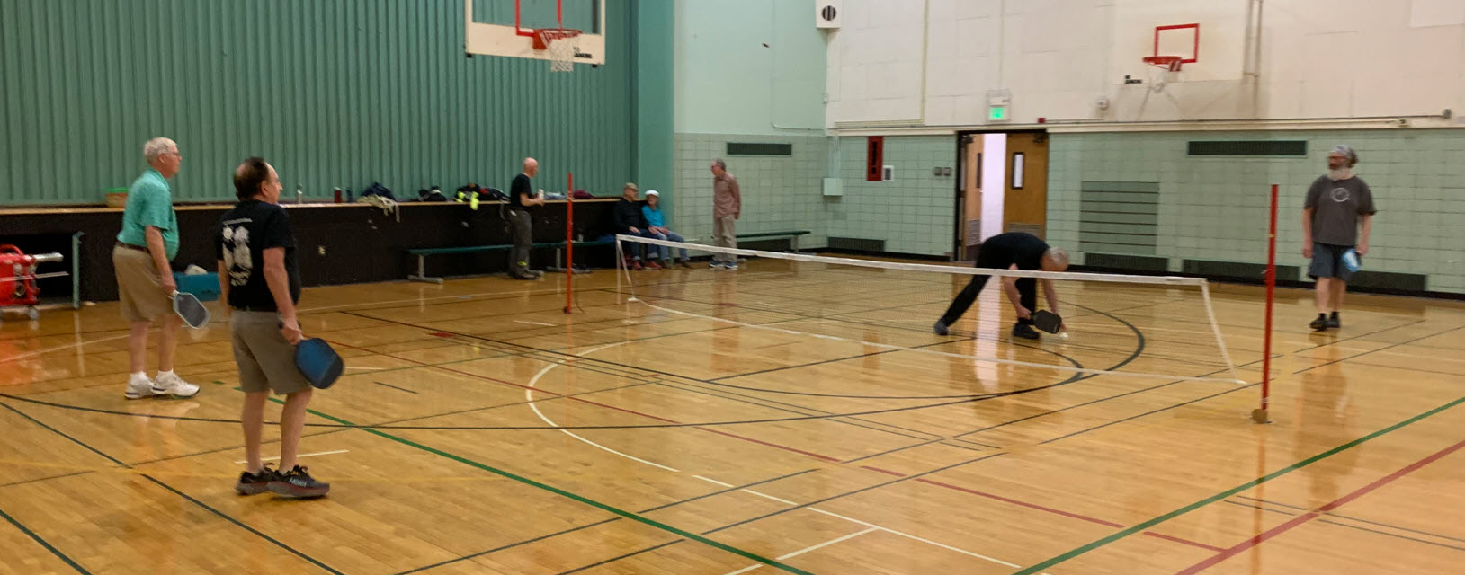 senior men playing pickleball
